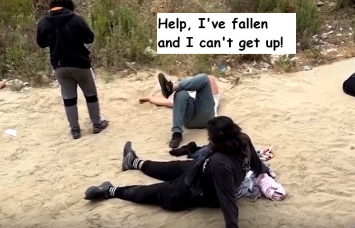 migrants fall off border wall.jpg